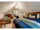 Upstairs bedroom featuring a large bed, loveseat, vaulted ceiling, and ensuite bathroom at 5578 Tabbs Creek Church Rd, Oxford, NC 27565