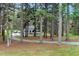View of the house down the wooded driveway at 5578 Tabbs Creek Church Rd, Oxford, NC 27565