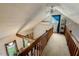 Hallway with wood railing overlooking a living space below and leading to a bedroom at 5578 Tabbs Creek Church Rd, Oxford, NC 27565