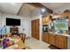 Functional kitchen with tile flooring, stainless steel appliances, and wood cabinetry at 5578 Tabbs Creek Church Rd, Oxford, NC 27565