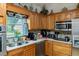 Kitchen boasting tile backsplash, stainless steel appliances and a window overlooking the backyard at 5578 Tabbs Creek Church Rd, Oxford, NC 27565