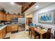 Well-lit kitchen features stainless steel appliances, wood cabinets, and an eat-in dining area at 5578 Tabbs Creek Church Rd, Oxford, NC 27565