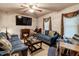Comfortable living room features a decorative fireplace, ceiling fan, and natural lighting at 5578 Tabbs Creek Church Rd, Oxford, NC 27565