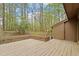 Enjoy outdoor relaxation on the large wooden deck overlooking wooded landscape at 58 Stoneridge Rd, Durham, NC 27705