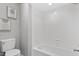 Bright bathroom with a white subway tile shower and toilet with modern artwork on the wall at 58 Stoneridge Rd, Durham, NC 27705