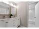 Bright bathroom featuring double sinks, modern fixtures, white cabinets, and large mirrors at 58 Stoneridge Rd, Durham, NC 27705