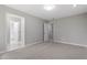Bright bedroom with neutral walls and carpet, features entrances to bathroom and hallway at 58 Stoneridge Rd, Durham, NC 27705