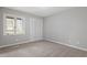 Clean bedroom with a closet and natural light, enhanced by neutral paint and new carpet at 58 Stoneridge Rd, Durham, NC 27705