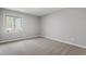 A cozy bedroom featuring a window with natural light and neutral carpeting at 58 Stoneridge Rd, Durham, NC 27705