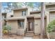 Charming two-story home with a well-maintained front yard, inviting entryway, and natural landscaping at 58 Stoneridge Rd, Durham, NC 27705
