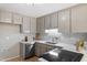 Updated kitchen featuring white countertops, tiled backsplash, stainless steel appliances, and gray cabinets at 58 Stoneridge Rd, Durham, NC 27705