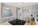Open kitchen with gray cabinets, quartz countertops, and stainless steel appliances at 58 Stoneridge Rd, Durham, NC 27705
