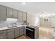Open kitchen featuring stainless steel appliances and hardwood floors, open to dining area at 58 Stoneridge Rd, Durham, NC 27705