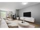 Bright living room with fireplace, wood floors, stylish furniture and decor, offers a warm and relaxing atmosphere at 58 Stoneridge Rd, Durham, NC 27705