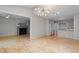 Spacious living room with modern light fixture, fireplace, and hardwood floors at 58 Stoneridge Rd, Durham, NC 27705
