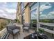 Relaxing balcony seating with city views, featuring modern furniture and an outdoor dining area at 601 W Rosemary St # 418, Chapel Hill, NC 27516