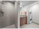 Bathroom featuring a walk-in shower, wood cabinets and a stacked washer and dryer at 601 W Rosemary St # 418, Chapel Hill, NC 27516
