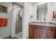Bathroom with walk-in shower, granite countertops, wood cabinets and decorative mirror at 601 W Rosemary St # 418, Chapel Hill, NC 27516
