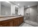 Bathroom with double vanity, granite countertops, modern shower with glass enclosure and neutral tile at 601 W Rosemary St # 418, Chapel Hill, NC 27516