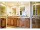 Spacious bathroom boasts double sinks, granite countertops, wood cabinets, and a glass enclosed shower at 601 W Rosemary St # 418, Chapel Hill, NC 27516