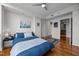 Bright bedroom featuring a ceiling fan, hardwood floors, and ensuite bathroom at 601 W Rosemary St # 418, Chapel Hill, NC 27516