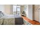 Cozy bedroom featuring hardwood floors, balcony access with outdoor seating, and a modern work space at 601 W Rosemary St # 418, Chapel Hill, NC 27516