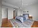 Bedroom features hardwood floors, ceiling fan, modern rug, ensuite bath, and closet access at 601 W Rosemary St # 418, Chapel Hill, NC 27516