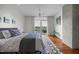 Bright bedroom with hardwood floors, modern rug, balcony access with outdoor seating and modern decor at 601 W Rosemary St # 418, Chapel Hill, NC 27516