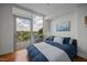 Bright bedroom with hardwood floors, balcony access, ceiling fan, and modern decor at 601 W Rosemary St # 418, Chapel Hill, NC 27516