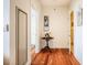 Entryway with hardwood floors leading to other rooms, decorated with art and a classic round table at 601 W Rosemary St # 418, Chapel Hill, NC 27516