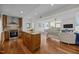 Open kitchen with a large island, stainless steel appliances, and hardwood floors at 601 W Rosemary St # 418, Chapel Hill, NC 27516
