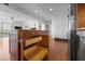 Kitchen island with granite countertops, wooden cabinets and drawers, hardwood floors and stainless steel appliances at 601 W Rosemary St # 418, Chapel Hill, NC 27516