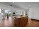 Open-concept living room with wood floors, kitchen island, modern furniture and a view of the city from the balcony at 601 W Rosemary St # 418, Chapel Hill, NC 27516