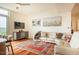 Comfortable living room featuring hardwood floors, a stylish rug, and a plush white sofa at 601 W Rosemary St # 418, Chapel Hill, NC 27516