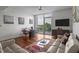 Open-concept living space with a view, hardwood floors, a couch, and a modern rug at 601 W Rosemary St # 418, Chapel Hill, NC 27516