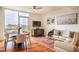Bright living room with hardwood floors, modern furnishings, and expansive windows with exterior views at 601 W Rosemary St # 418, Chapel Hill, NC 27516
