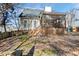 Photo of backyard, featuring a partially screened porch and wooded yard at 605 Lakeview Ave, Wake Forest, NC 27587