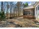 Backyard shows a partially screened porch, wooden fence, and wooded area at 605 Lakeview Ave, Wake Forest, NC 27587