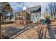 Backyard shot shows home with partially screened porch and wooded yard at 605 Lakeview Ave, Wake Forest, NC 27587