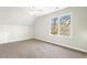 Bright bedroom featuring neutral walls, carpeted floors, and a large window at 605 Lakeview Ave, Wake Forest, NC 27587