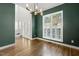 Dining room highlighting modern lighting, hardwood floors, a view to the foyer, and exterior views through the window at 605 Lakeview Ave, Wake Forest, NC 27587