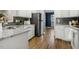 Well-lit kitchen showcasing stainless steel appliances, granite countertops and white cabinets with modern backsplash at 605 Lakeview Ave, Wake Forest, NC 27587