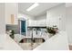 Bright kitchen featuring granite countertops, modern stainless steel sink and white cabinetry offering lots of storage at 605 Lakeview Ave, Wake Forest, NC 27587