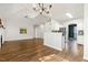 Open-concept living room with hardwood floors, vaulted ceilings and abundant natural light flowing into the kitchen area at 605 Lakeview Ave, Wake Forest, NC 27587