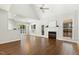 Open living area with hardwood floors, vaulted ceilings, fireplace, and large windows with plantation shutters at 605 Lakeview Ave, Wake Forest, NC 27587