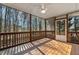Covered patio features wood floors, ceiling fan, and a scenic wooded view at 605 Lakeview Ave, Wake Forest, NC 27587