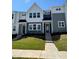 Charming townhome with well-manicured lawn and inviting front entrance on a sunny day at 609 Callan View Ave, Wake Forest, NC 27587