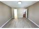 Spacious bedroom with laminate floors and entry ways on either side of the room at 6705 Somerknoll Dr, Durham, NC 27713