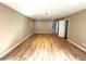 Spacious bedroom with hardwood floors, neutral walls, and ample natural light at 6705 Somerknoll Dr, Durham, NC 27713