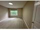 Bright bedroom with laminate floors and view of the outdoors through the window at 6705 Somerknoll Dr, Durham, NC 27713